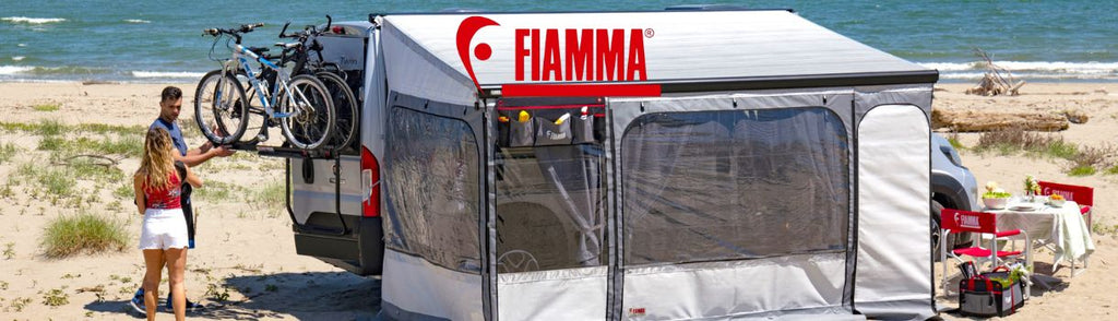 Fiamma awning and bike rack pitched up near a beach