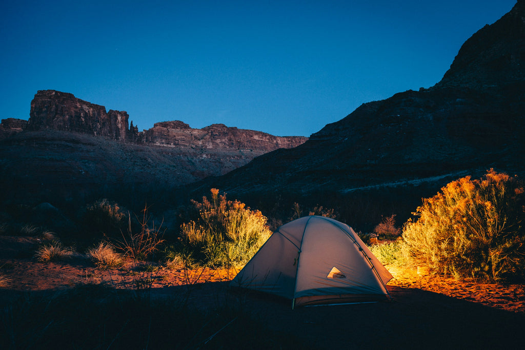 Tent in the mountains at sunset